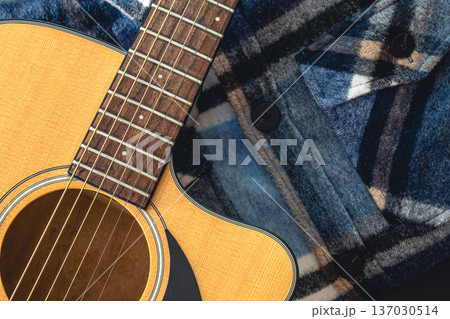 Close-up, acoustic guitar on the background of the shirt. Close-up, acoustic guitar on the background of the shirt. 137030514