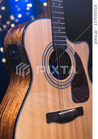Close-up, acoustic guitar on a dark background with bokeh lights. Close-up, acoustic guitar on a dark background with bokeh lights. 137030518