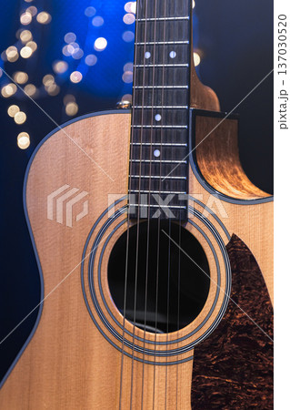 Close-up, acoustic guitar on a dark background with bokeh lights. 137030520