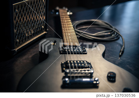 Close-up, black electric guitar on a dark background. Close-up, black electric guitar on a dark background. 137030536