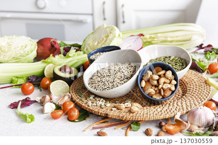 Close-up, a bowl of chia seeds and other healthy foods on the kitchen table. 137030559