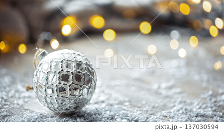 Festive background with Christmas ball and blurred bokeh lights, copy space. Festive background with Christmas ball and blurred bokeh lights, copy space. 137030594