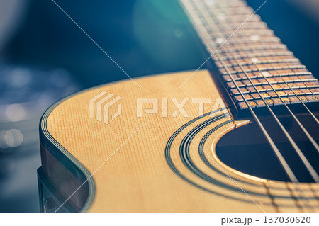 Acoustic guitar on a black background in the light of a spotlight. 137030620