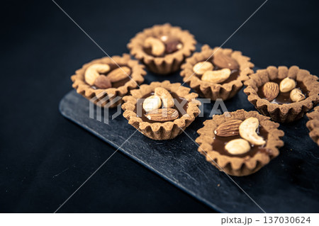 Close-up of cookies in the form of baskets with nut filling. 137030624