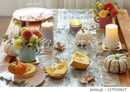 Festive table setting with pumpkins and chrysanthemum flowers. Festive table setting with pumpkins and chrysanthemum flowers. 137030627