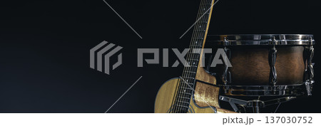 Acoustic guitar and snare drum on a black background isolated. 137030752