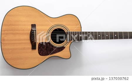Acoustic guitar on a white background, top view, copy space. Acoustic guitar on a white background, top view, copy space. 137030762
