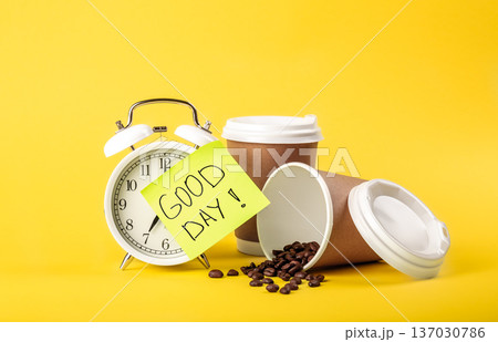 Alarm clock, paper cup, paper reminder and coffee beans on yellow background. 137030786