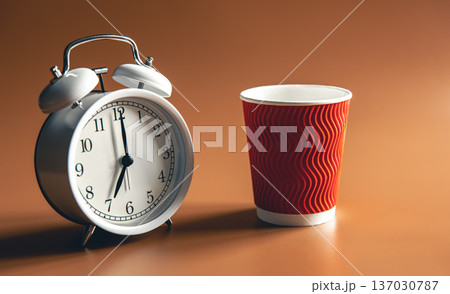 Alarm clock and paper disposable cup of coffee. 137030787