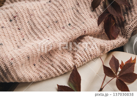 Autumn background with a knitted element, a cup of tea and autumn leaves. 137030838