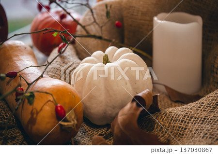 Autumn composition with pumpkins on burlap close-up. 137030867