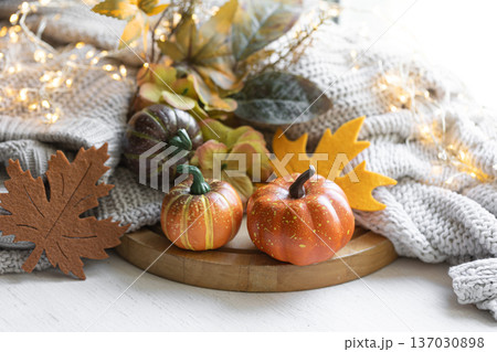 Autumn still life with pumpkins, leaves and knitted element. Autumn still life with pumpkins, leaves and knitted element. 137030898