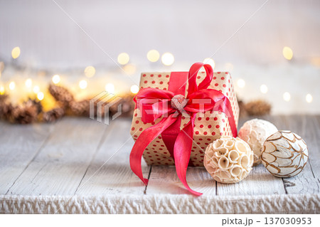 Beautiful Christmas background with Christmas toys and a gift box. Beautiful Christmas background with Christmas toys and a gift box. 137030953