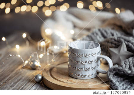 Beautiful Christmas cup on a blurred background with bokeh. Beautiful Christmas cup on a blurred background with bokeh. 137030954