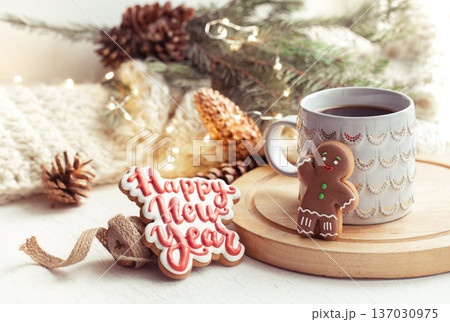Christmas composition with beautiful cup and gingerbread cookies with happy new year wishes. Christmas composition with beautiful cup and gingerbread cookies with happy new year wishes. 137030975