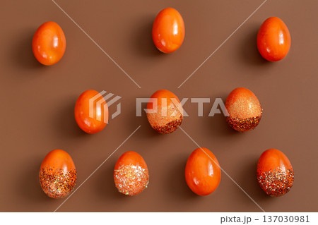 Beautiful Easter background with orange decorative eggs. 137030981