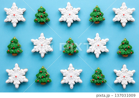 Beautiful handmade Christmas glazed gingerbread cookies on a blue background. Beautiful handmade Christmas glazed gingerbread cookies on a blue background. 137031009