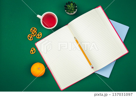 Blank notepad on green background, school concept, flat lay. Blank notepad on green background, school concept, flat lay. 137031097