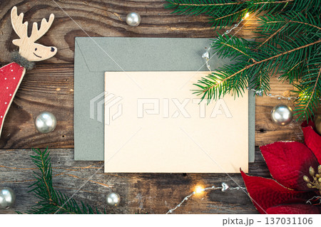 Blank paper, envelope and Christmas decor on wooden background, copy space. 137031106