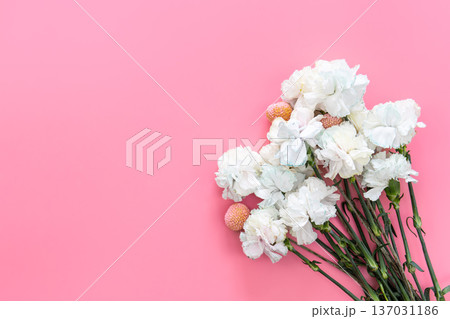 Bouquet of white carnations on a pink background isolated, flat lay. Bouquet of white carnations on a pink background isolated, flat lay. 137031186