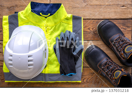 Builder uniform on wooden background, flat lay. 137031218