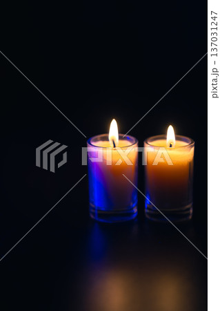 Burning candle on black background with backlight. Memorial Day. 137031247