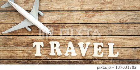 Word Travel and airplane on wooden background. Word Travel and airplane on wooden background. 137031282