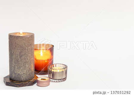 Burning candles on a white background isolated. Burning candles on a white background isolated. 137031292