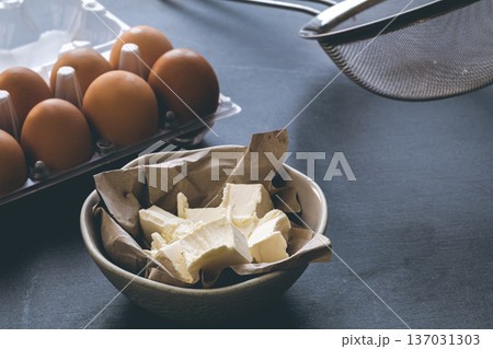 Butter and eggs on the kitchen table, close-up. Butter and eggs on the kitchen table, close-up. 137031303
