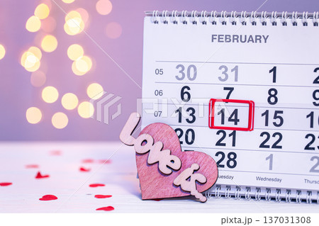 Calendar with the date February 14, a festive background for Valentine's Day. Calendar with the date February 14, a festive background for Valentine's Day. 137031308