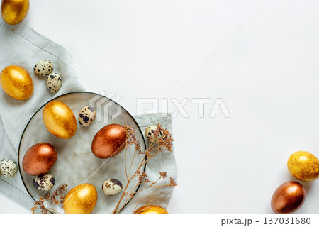 Golden and bronze Easter eggs in a gray plate Golden and bronze Easter eggs in a gray plate 137031680