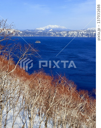 冬の摩周湖の青い湖面と雪山の眺め。 137031686