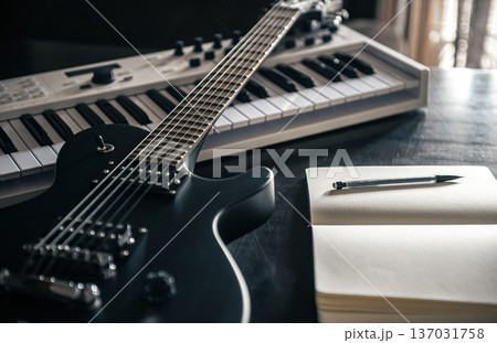 Close up, electric guitar and piano, musical creativity concept. Close up, electric guitar and piano, musical creativity concept. 137031758