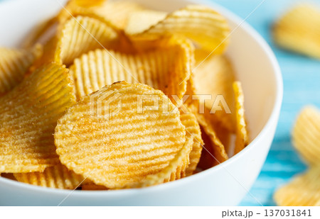 Close-up, a plate of potato chips on a blurred background. 137031841
