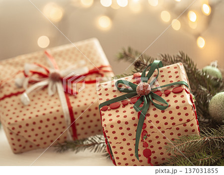 Close up nicely wrapped christmas gifts on blurred background. Close up nicely wrapped christmas gifts on blurred background. 137031855