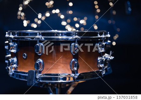 Close-up, snare drum on a blurred background with bokeh lights. Close-up, snare drum on a blurred background with bokeh lights. 137031858