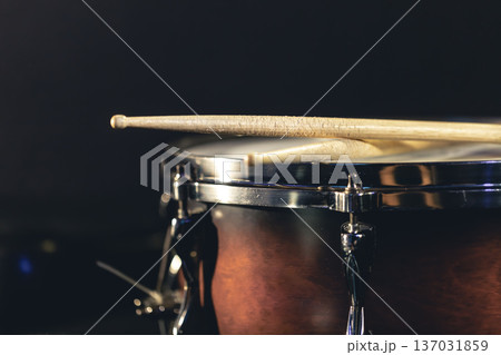 Close-up, snare drum and drumsticks on a dark background. Close-up, snare drum and drumsticks on a dark background. 137031859
