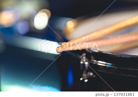 Close-up, snare drum and drumsticks on a dark background. Close-up, snare drum and drumsticks on a dark background. 137031861