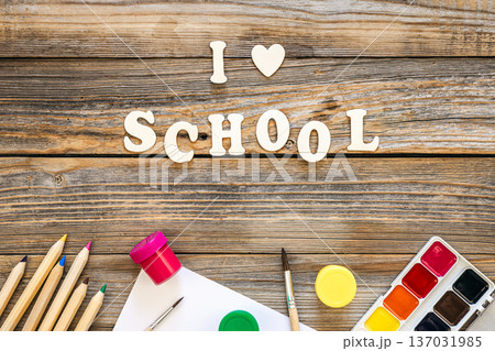 Colorful school supplies on wooden background, back to school concept. Colorful school supplies on wooden background, back to school concept. 137031985