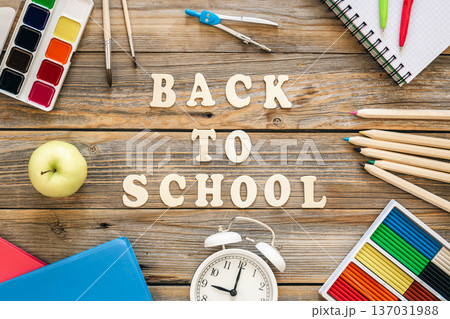 Colorful school supplies on wooden background, back to school concept. Colorful school supplies on wooden background, back to school concept. 137031988