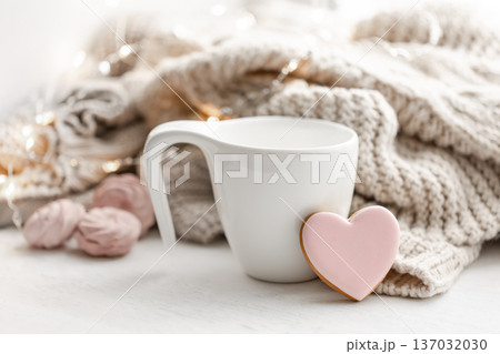 Composition for Valentine's Day with a cup and a heart-shaped gingerbread. 137032030