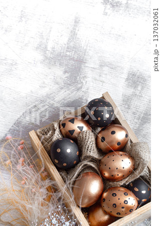 Composition with Easter eggs painted in gold and black. Composition with Easter eggs painted in gold and black. 137032061