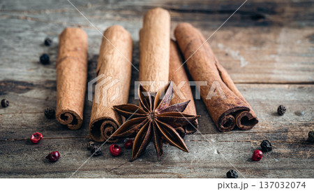 Composition with star anise and cinnamon sticks on a wooden background. Composition with star anise and cinnamon sticks on a wooden background. 137032074