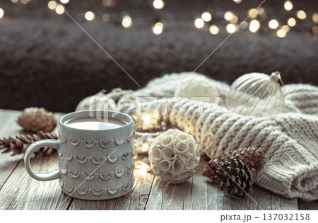 Home winter composition with coffee cup and decor details on blurred background. Home winter composition with coffee cup and decor details on blurred background. 137032158