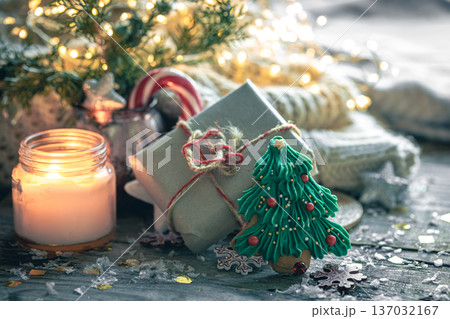 Cozy Christmas composition with a burning candle and decorative details. Cozy Christmas composition with a burning candle and decorative details. 137032167