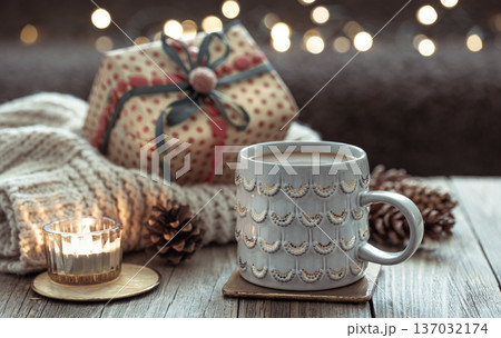 Christmas cozy background with a beautiful cup and decorative details. Christmas cozy background with a beautiful cup and decorative details. 137032174