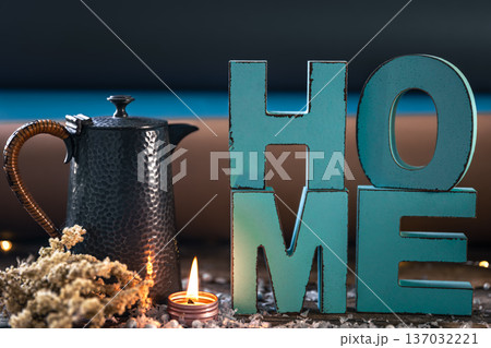 Cozy composition with decorative word home, teapot and candle. 137032221