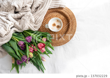 Cozy composition with flowers and coffee on a white background, top view. 137032229