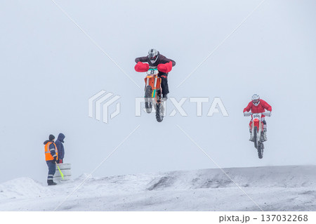 Two motocross riders airborne 137032268