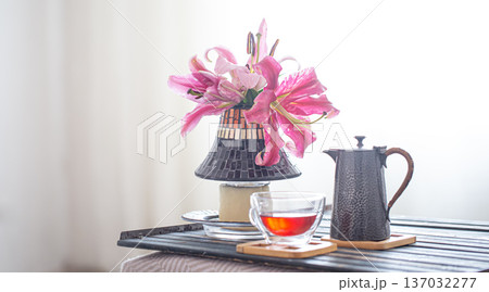 Wooden tray with teapot and Cup of tea and beautiful Lily flowers. Wooden tray with teapot and Cup of tea and beautiful Lily flowers. 137032277